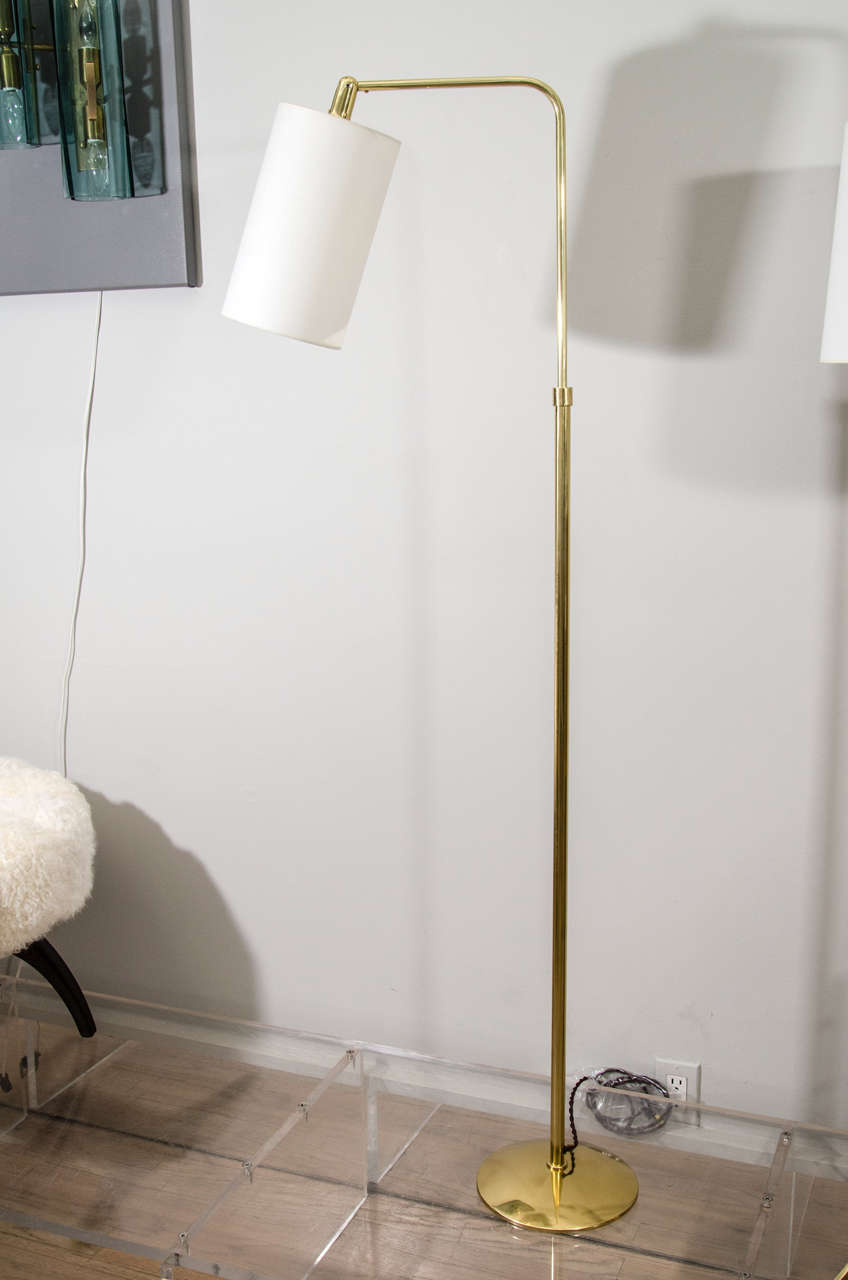 Pair of reading lamps in brass with paper shades.
 