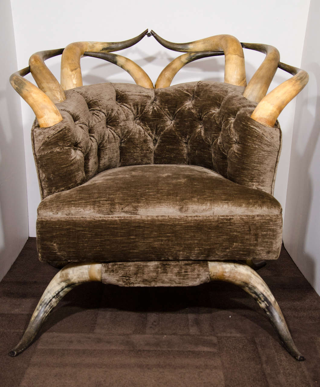 Oustanding Victorian tufted club chair with rare and unique long horns and steer horns.  The chair has a barrel or tub design and has been newly upholstered in a luxe mushroom textured velvet.
Steer horns are strategically designed along the upper