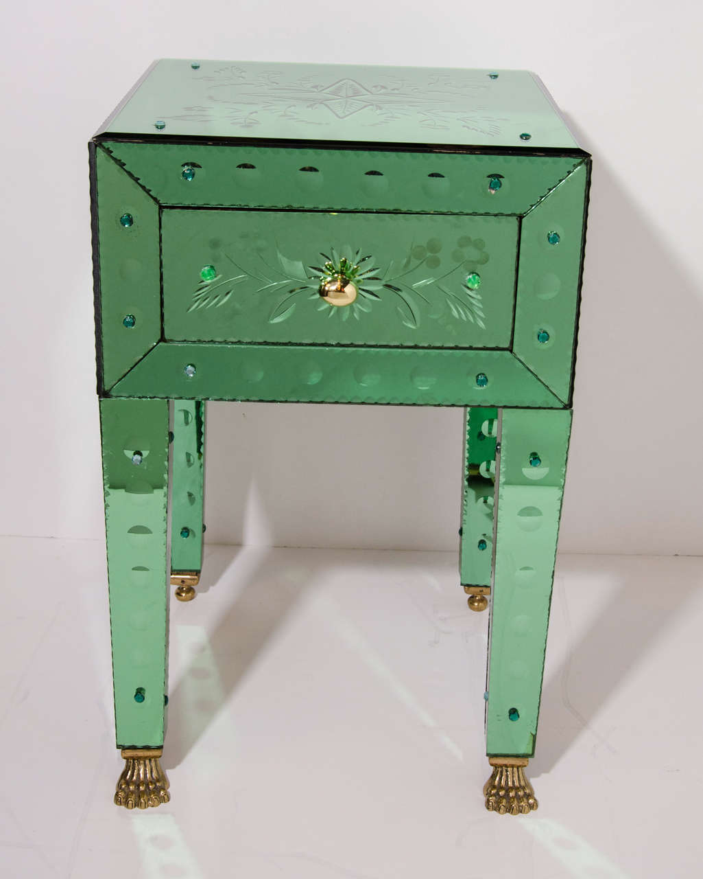 Pair of exquisite Venetian mirrored end tables with emerald green tinted glass.  The end tables / night stands  have a series of reverse etched floral designs as well as convex circle patterns throughout the legs and fronts. The tables have chain
