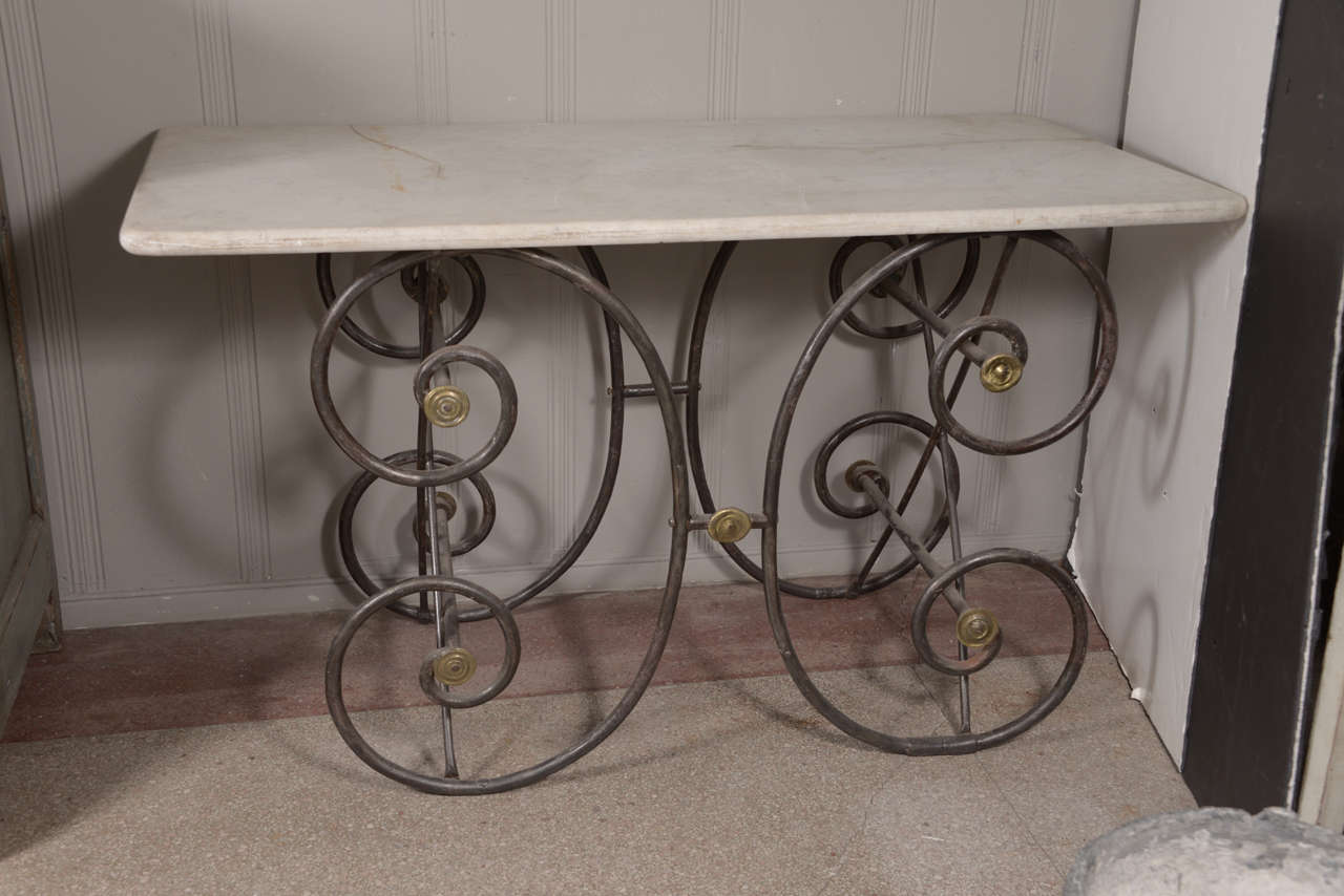 Curved iron legs.
Brass decorative trim.
Very graceful appearance.
Original white marble top.