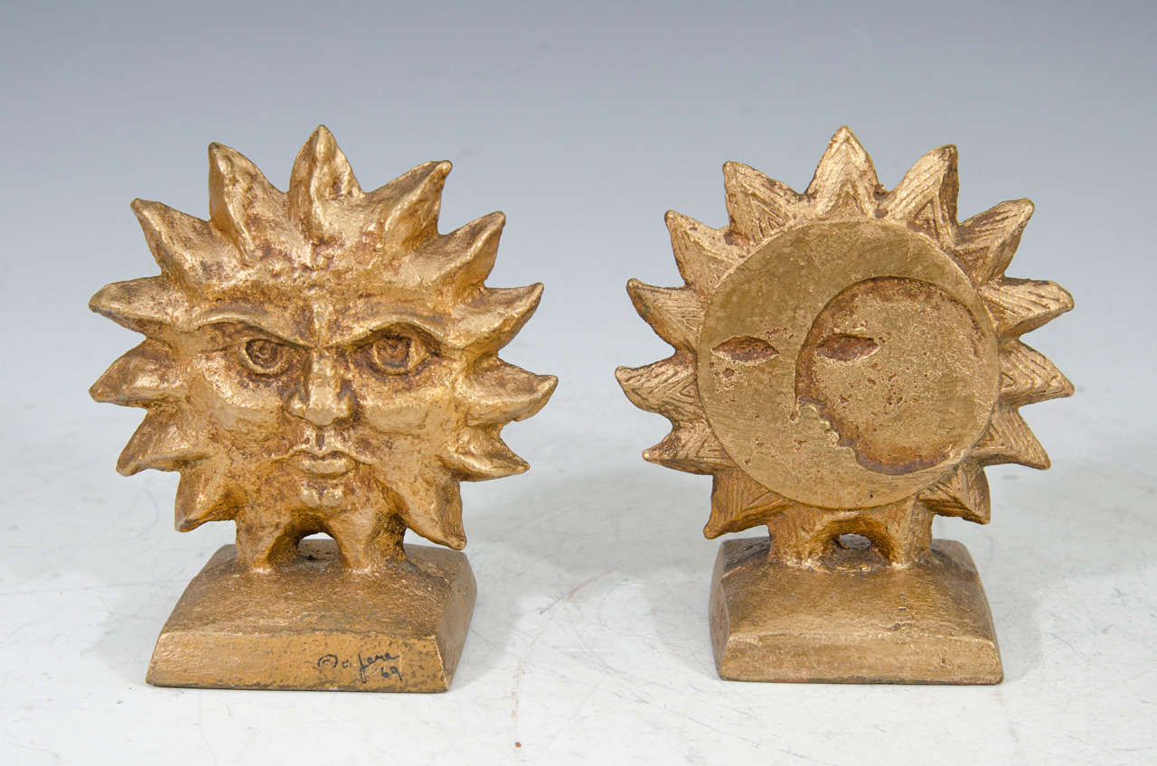 A vintage pair of Curtis Jere sunburst bookends with reversible sun and moon. Signed and dated 