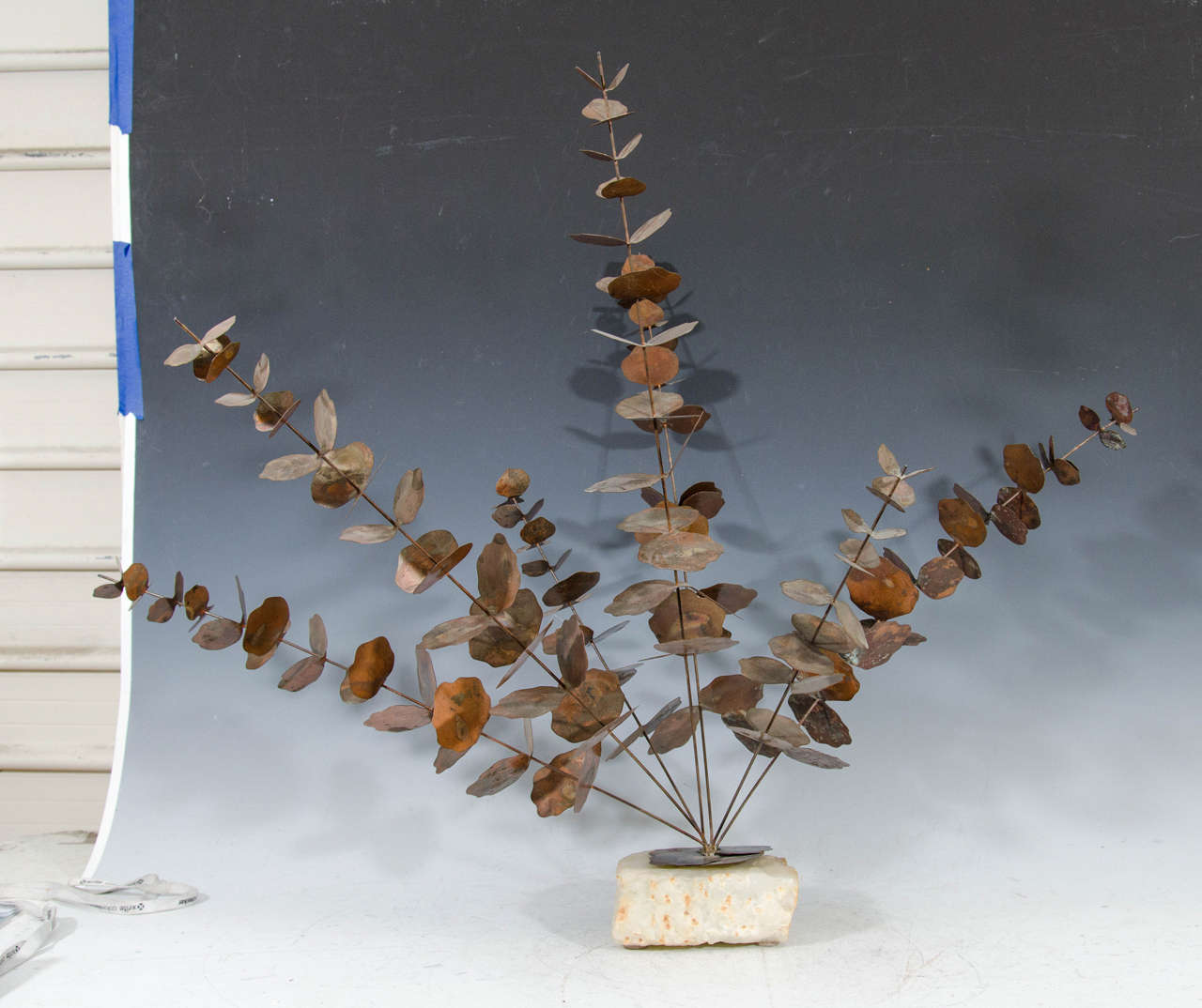 A vintage copper eucalyptus tree sculpture on a rock base.

Good vintage condition with age appropriate patina.