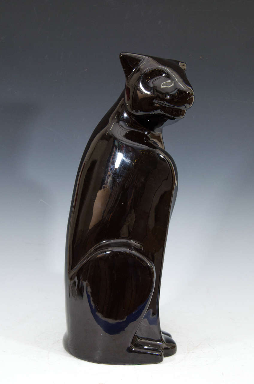 Vintage Art Deco style 6048 black seated sculpture or statue of a panther by Haeger Pottery. It retains a partial Haeger label on the bottom.