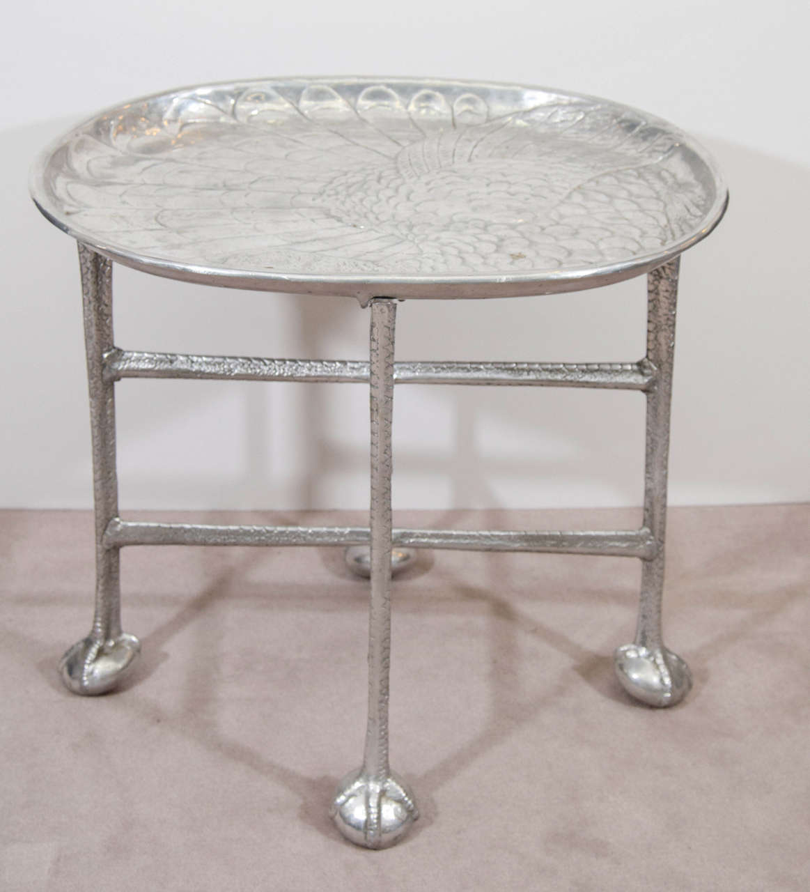 A 20th century Arthur Court aluminum oval turkey platter or serving tray on an aluminum stand with ball and claw feet. The back side of the tray has four talons used to stabilize the tray on stand. Stamped 