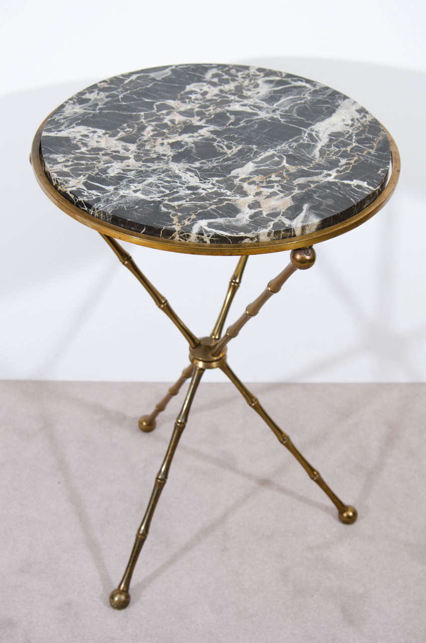 A vintage set of two Italian cocktail or drink tables. One table has a marble top with pink with white veins. The other has a black marble top with white veins. Both tables have faux bamboo bronze tripod bases.

Good vintage condition with age