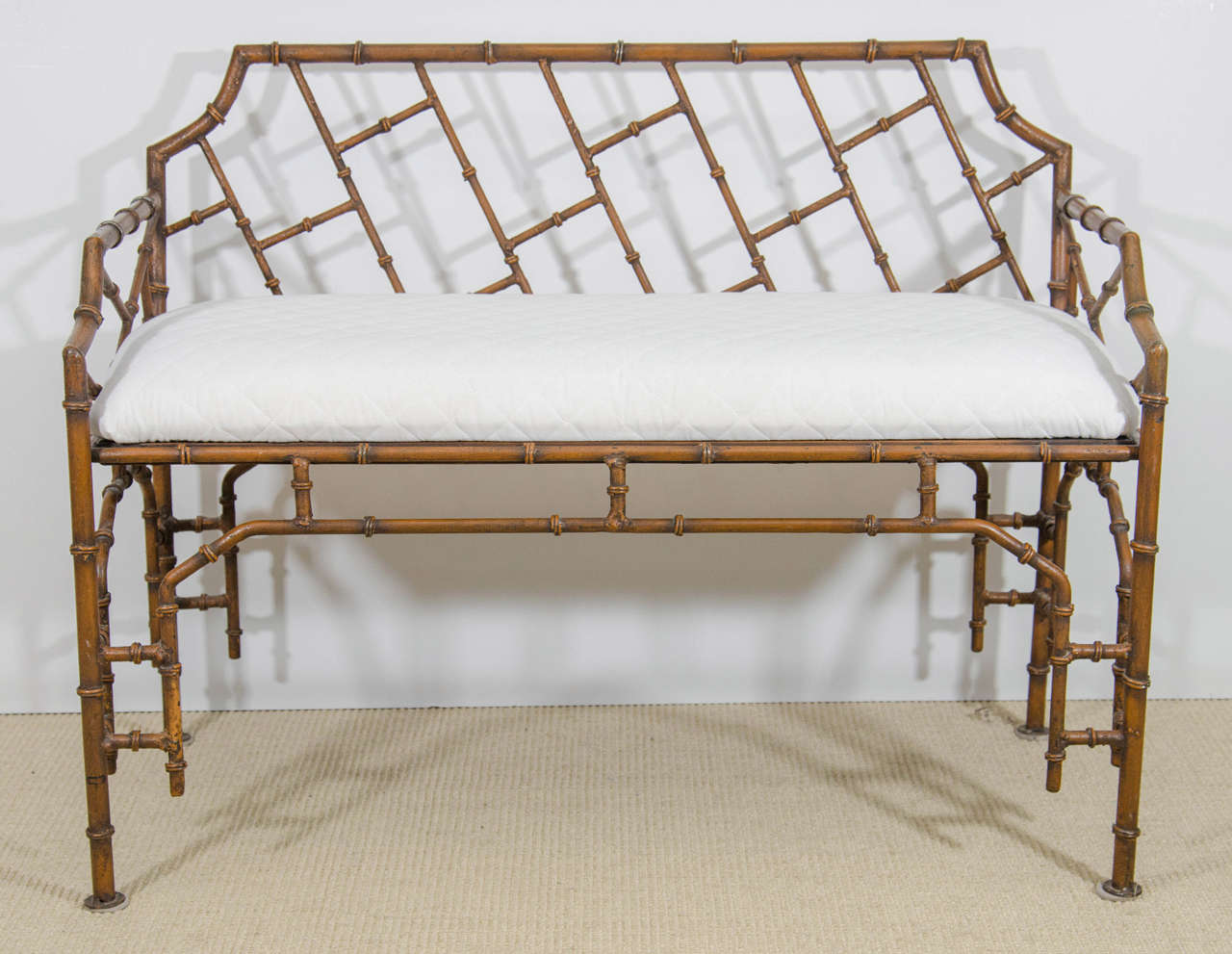 A vintage copper colored iron Faux bamboo bench with white upholstered cushion.

Good vintage condition with age appropriate wear.

Reduced from: $3,450