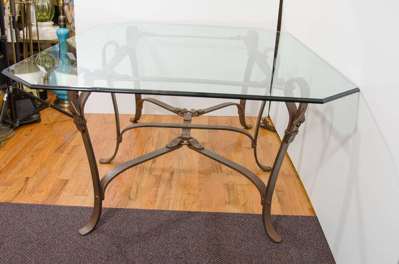 A Gucci influenced equestrian hand-forged iron table with glass top. Can be used as a coffee, center, or dining room table. A well formed and substantial piece, fitting for many interior influences.

 