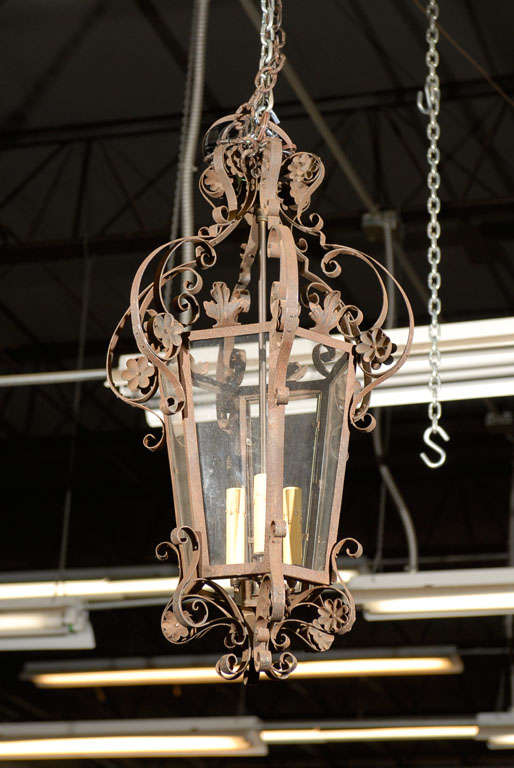 A French lantern with scrolled iron embellishments and small flowers for an added dainty touch.