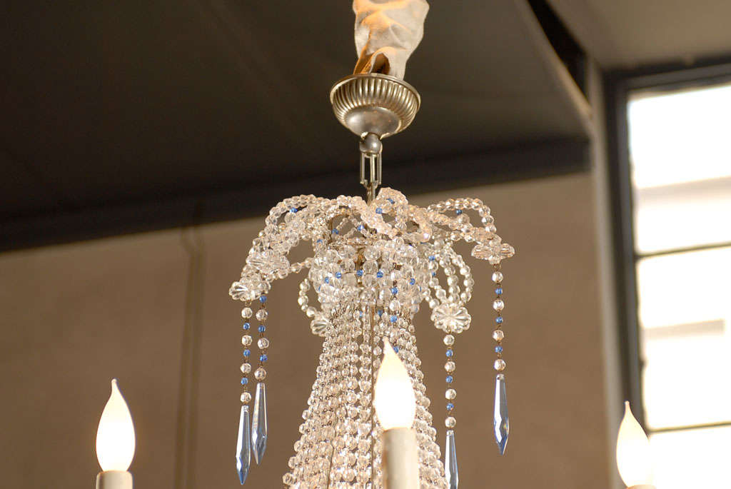 Dripping in crystals both blue and clear makes this chandelier very dressy. It is on the small size so it would be great in a powder room as well as other rooms that need a dainty dressy chandelier to bring sparkle to the room.