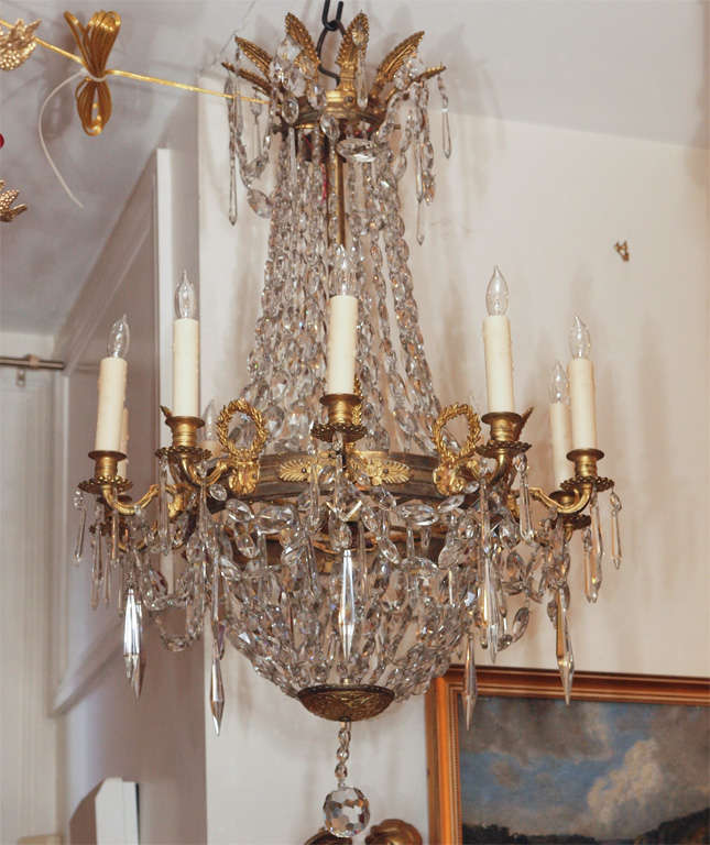 French Empire gilt bronze 10 light chandelier. This is unusual for this size to have so many lights. 
Great quality bronze work.