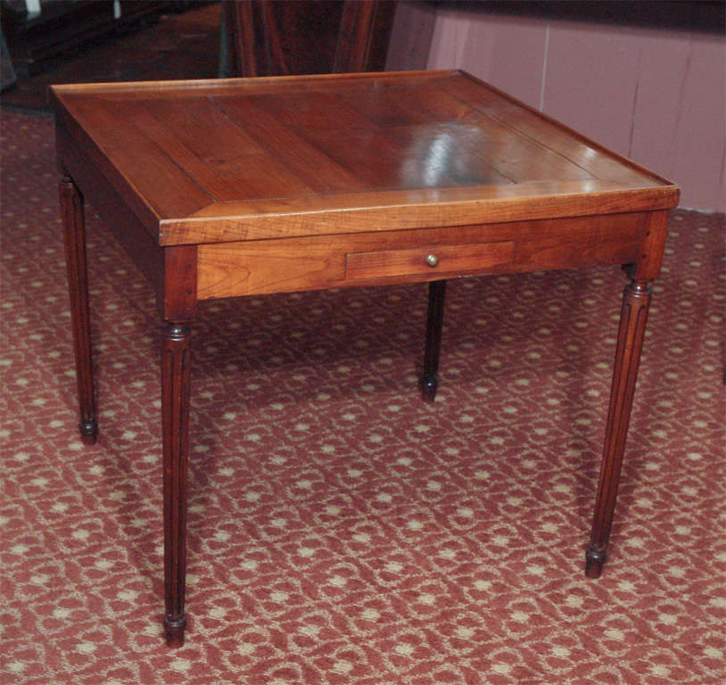 French Louis XVI period walnut games tables with fluted legs and two drawers, circa 1780