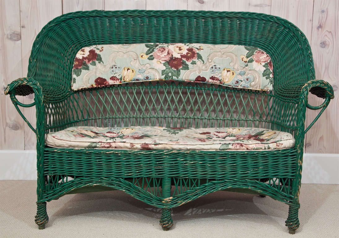 Large scale willow settee in old green paint.  Paint is chipped in some places. Original cushions included.

Dimensions are 61