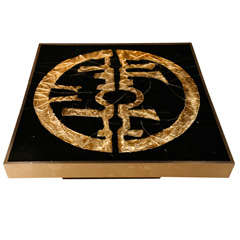 Square black coffeetable with an eclectic sign in gold