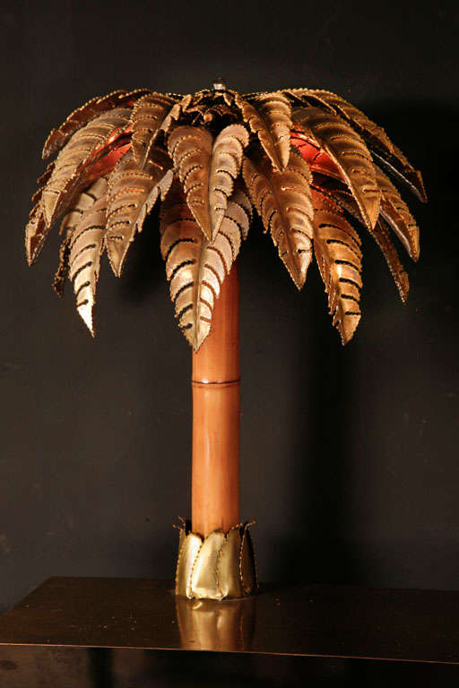 beautiful console consisting of a fully copper plated wooden stand with 2 brass and bamboo palmtrees coming out. 2 lightsources in each palm. This piece is ment as a wall-console, the original glass top that goes on top of the palmtrees comes with