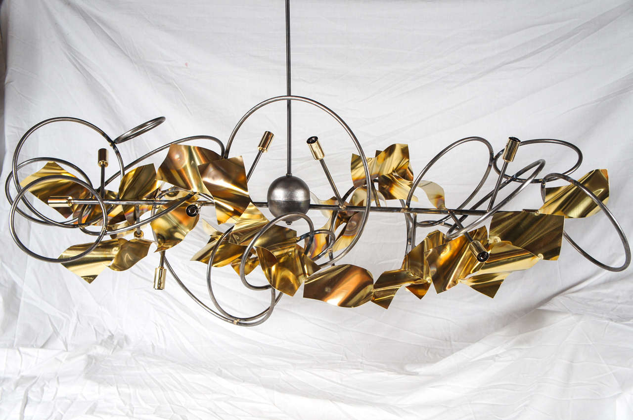 A handcrafted steel and brass chandelier made to order. It is available in many sizes and colors, and combinations.