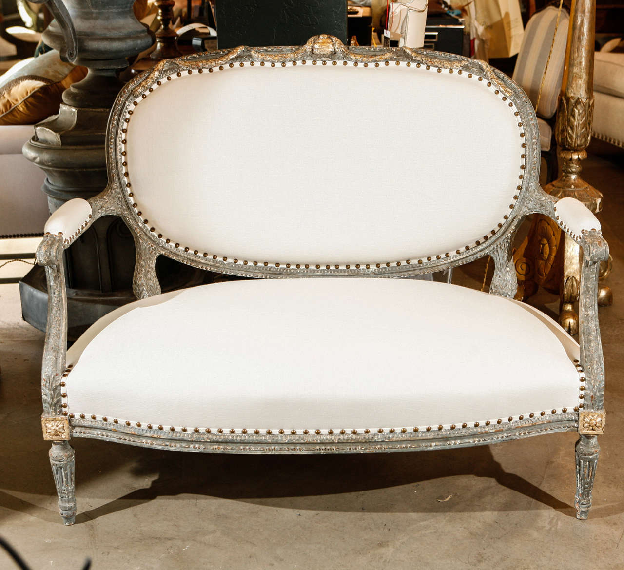 Beautifully old painted with gilt wood. Highlights, Upholstered in Belgian Linen with spaced nail head trim.