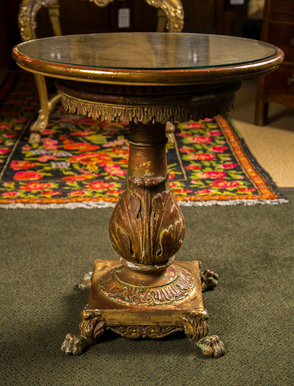 A wonderfully carved and gilt Italian side table  with paw feet and incised top.