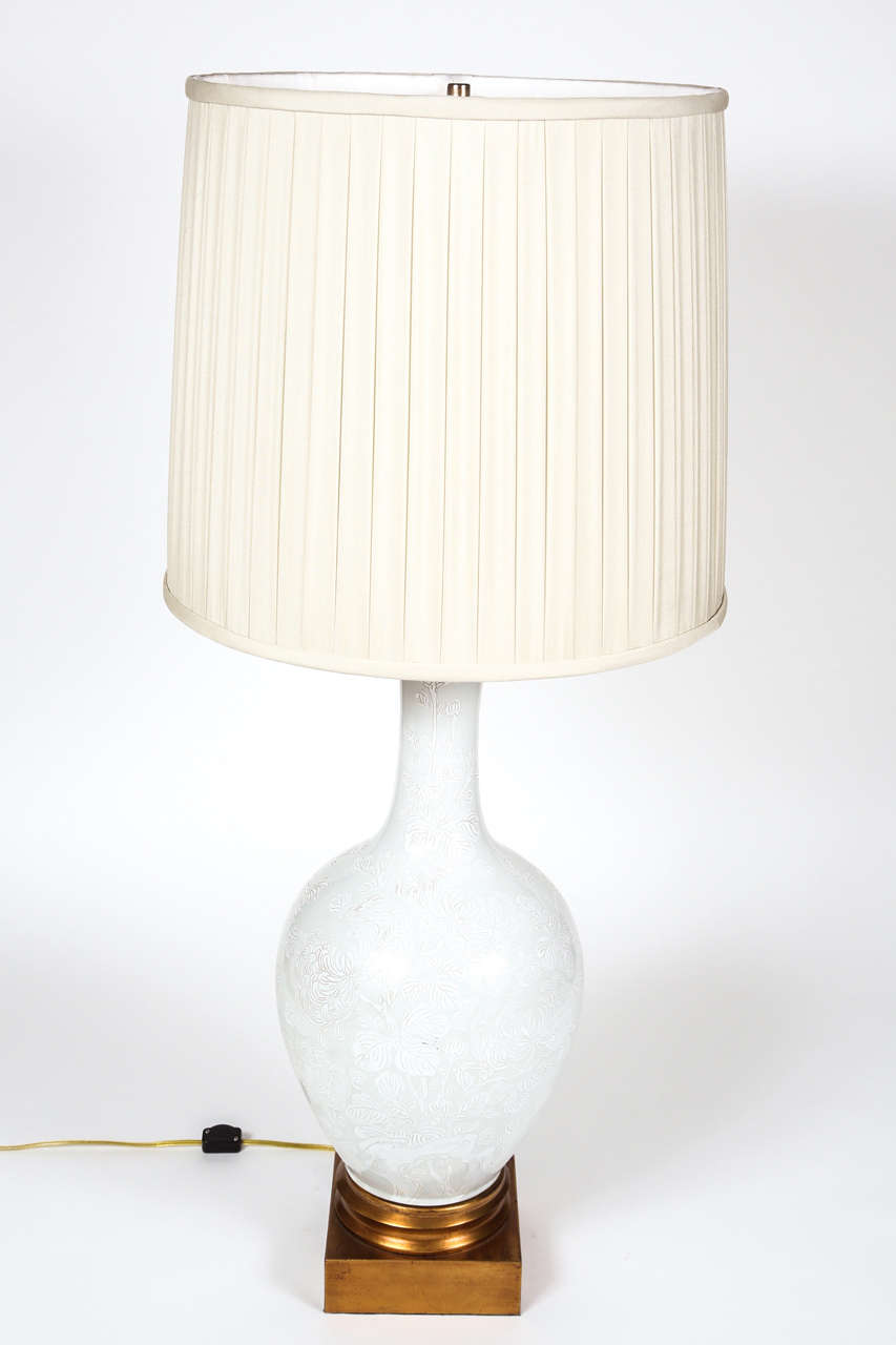 Mid-century Marbro table lamp with gilded wooden base.  Pale celedon ceramic urn shape with chrysanthemum motif.  Cord switch with two brightnes settings.   Pleated ivory silk lampshade sold separately.

DIMENSIONS: 10