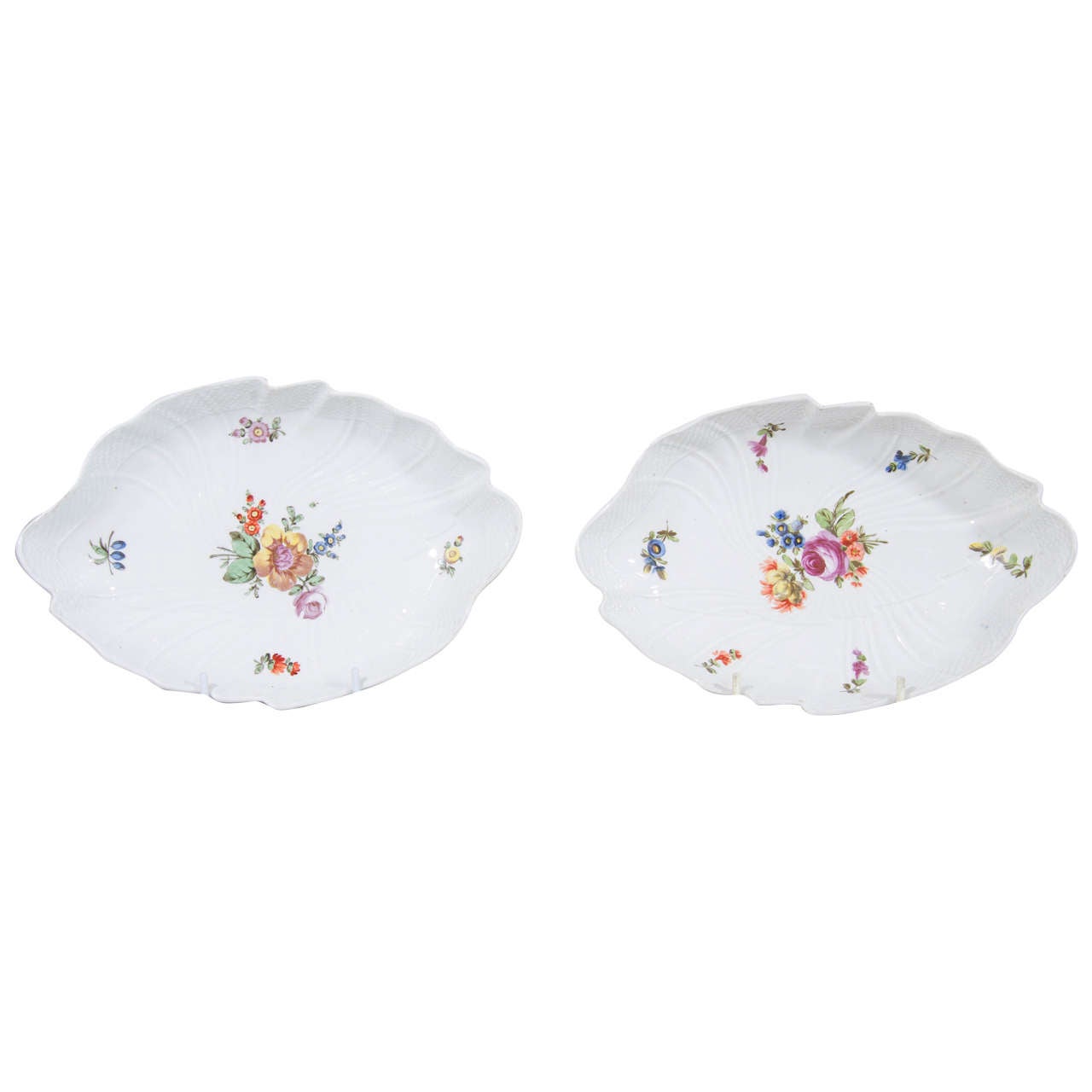 A lovely pair of 18th century hard paste porcelain dishes shaped as leaves. Molded in the style of Meissen with a border of double-curved ribbing and a band of fine osier basketwork at the edge. Each painted with a beautiful bouquet and detached