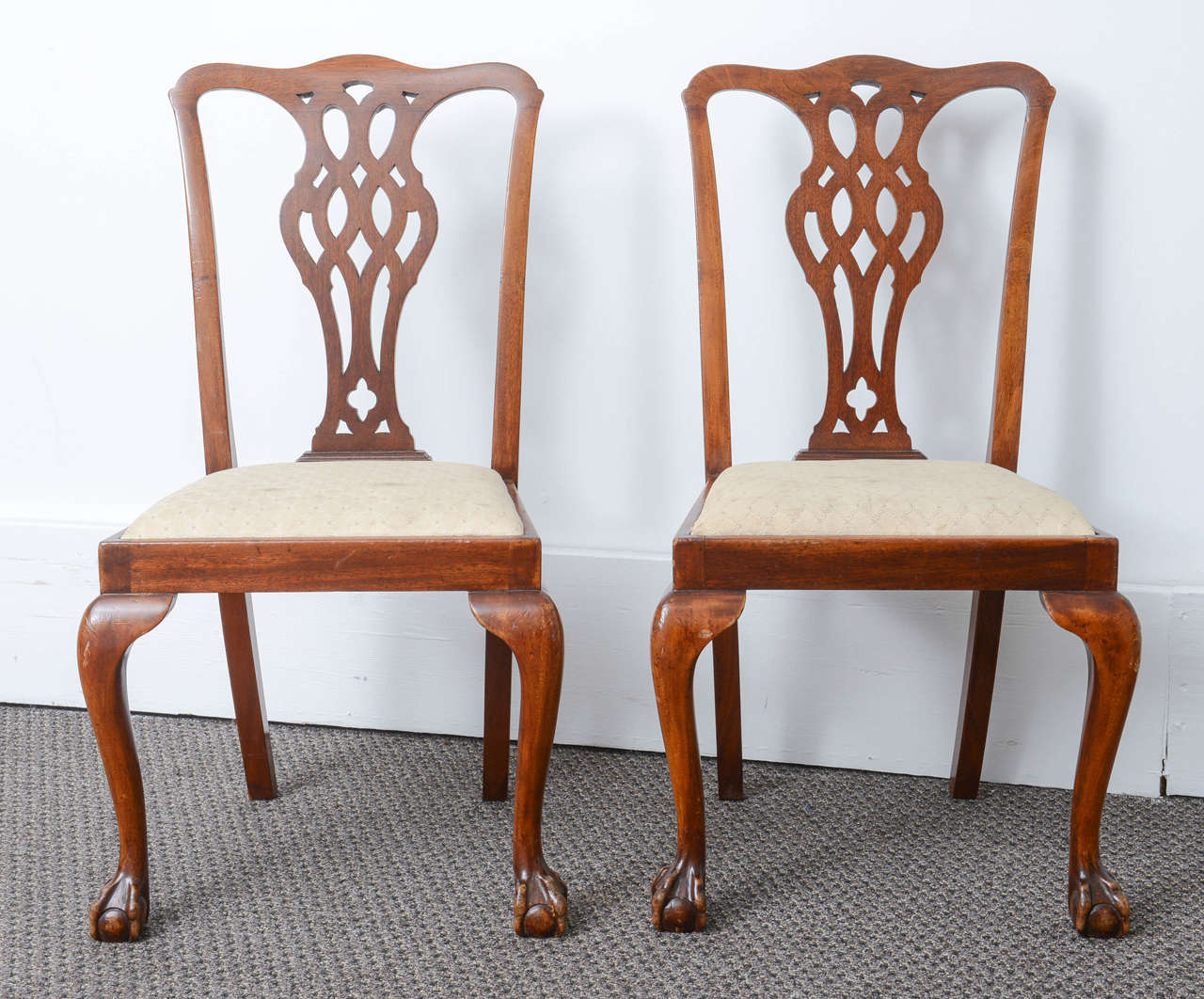 These are a very nice set of six dining chairs in mahogany. They sit on ball and claw feet they have a drop in seat and have a typical Chippendale style back. The color is a very nice brown with the original finish, and they are very sturdy.