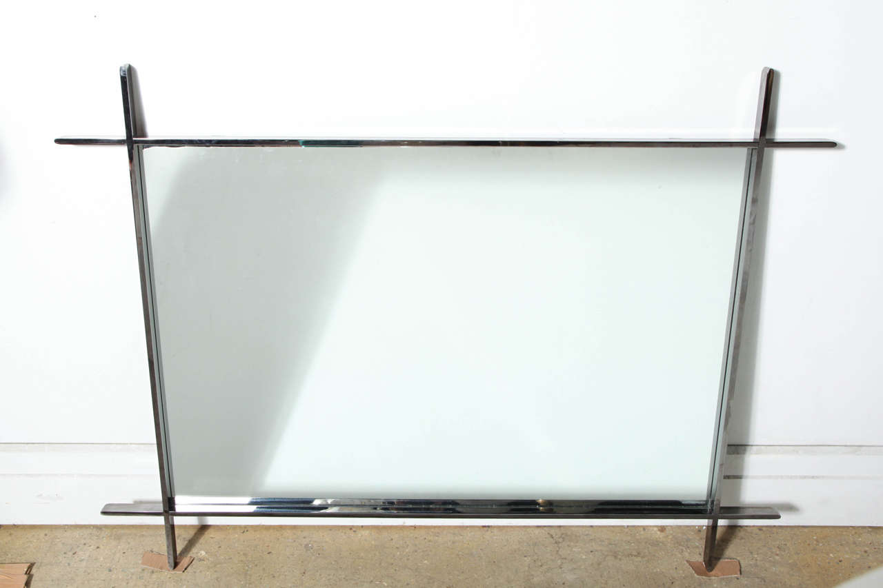 Substantial 1960's Adirondack Modern Reflective Polished Steel Mirror. Featuring a rectangular crossed corner frame design in solid Polished Steel, with rounded edge detail. Interior mirror size (32H x 47W). Minimalist. Subtle. Sculptural. Superb