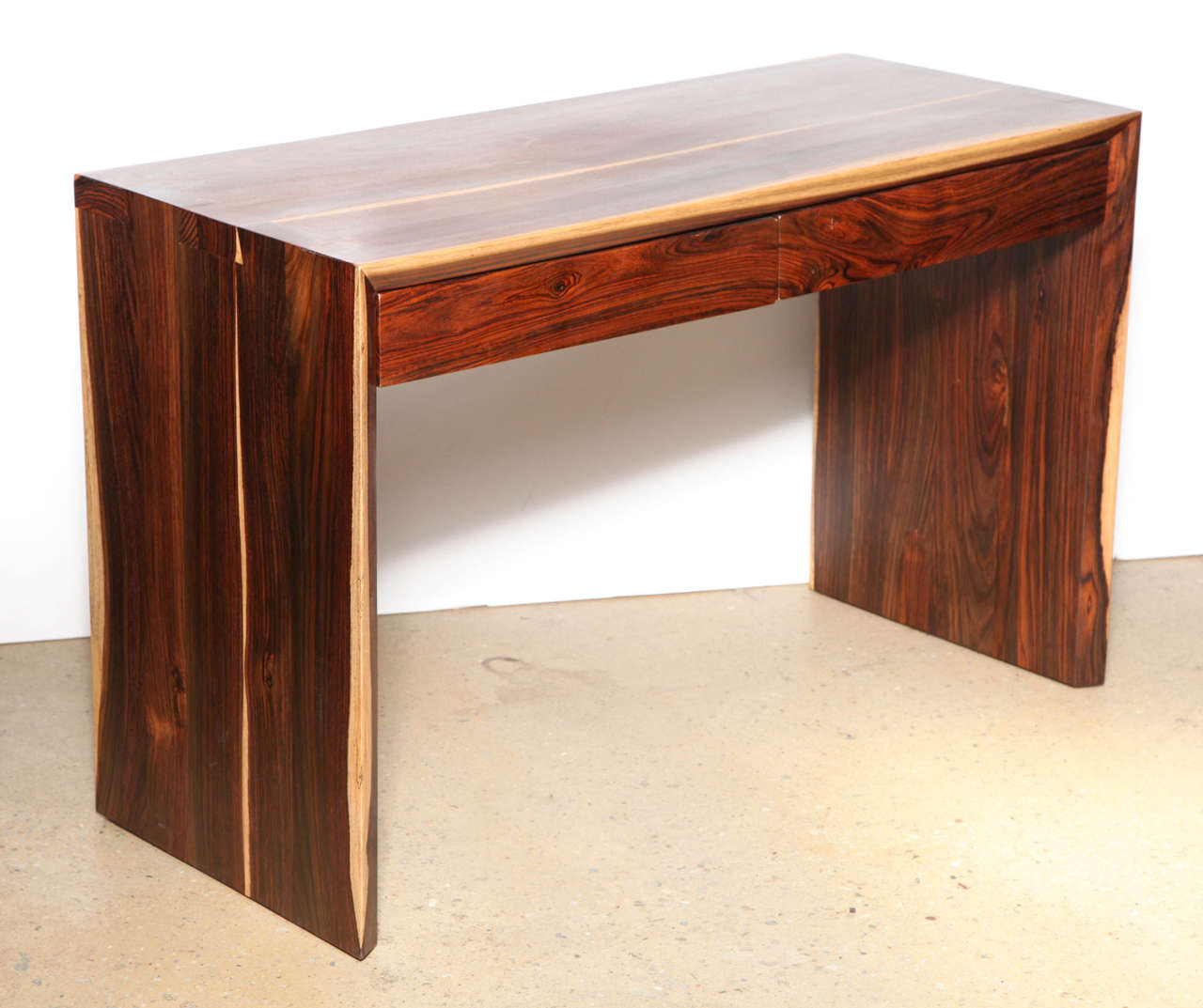1980's Modern Parsons style 2 drawer Cocobolo Desk. Uniquely crafted Studio piece with 45 degree front, featuring Light to Dark deeply grained Mexican Cocobolo Wood, dado joints and two side by side drawers.  24.75
