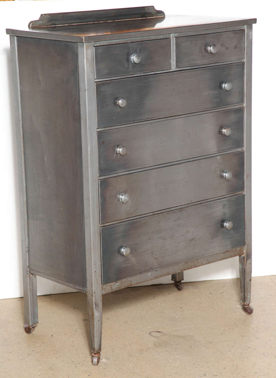 Elegant early 20th Century Steel Dresser with easy access to: two top and four large bottom drawers. Created in response to the Great Pandemic. Excellent storage. Paint removed