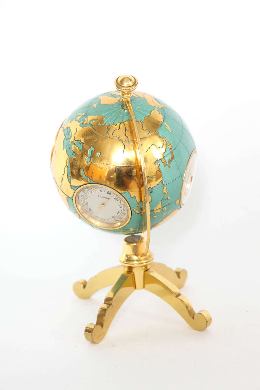 A fabulous globe bulova barometer and clock on brass stand with hygro and humidity dial, celsius dial, clock marked Angelus on the face and Bulova Watch Company on the back along with a barometer. The globe marks the land in brass and the seas in