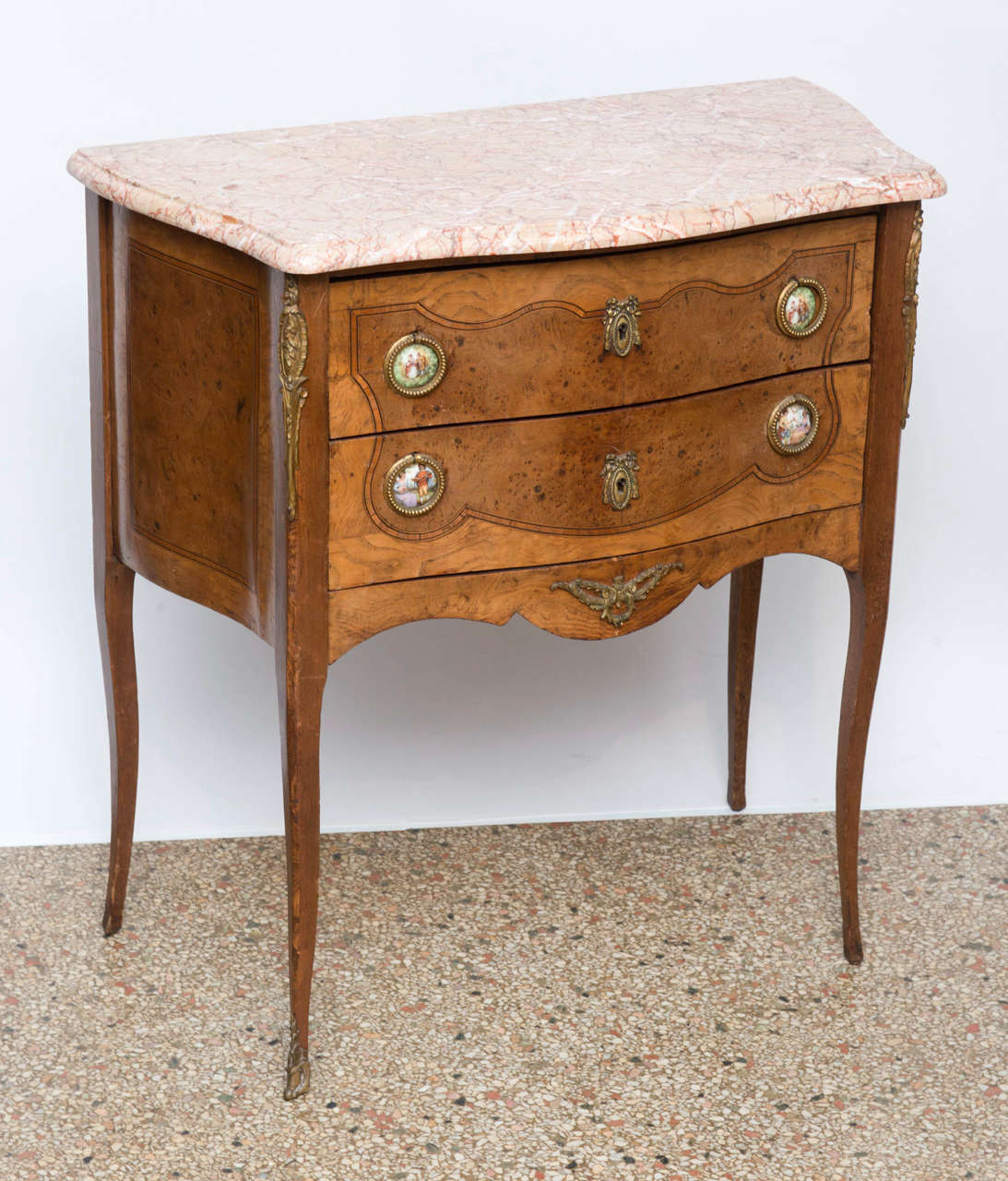 Finely crafted commode made of satinwood with inlays, ormolu mounted. Porcelain circular plaques are incorporated into the drawer pulls. Removable, shaped marble-top. Original restored finish.

Originally $ 2,500.00

PLEASE VISIT OUR SITE FOR