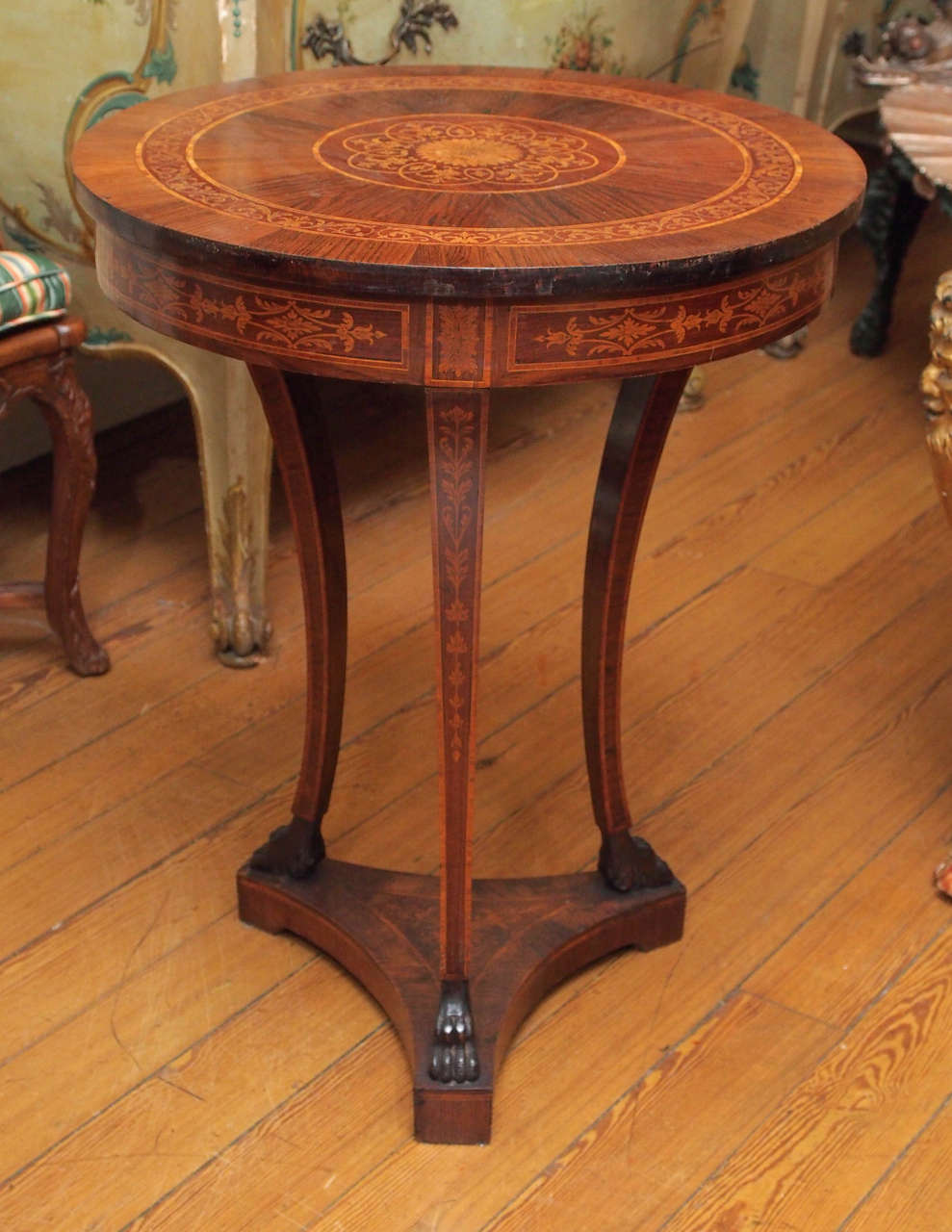 Italian Directoire Marquetry table with a trifed base with three paw footed legs and a skirted top