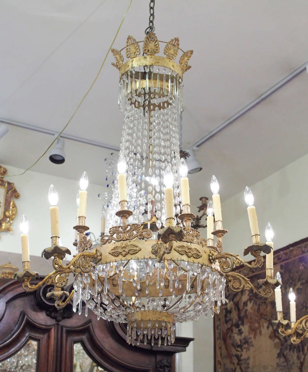 Pair of Italian Empire Gilt Iron and Crystal Chandelier, 19th century Palermo. Gilt Iron Stem with a palmette Corona and two tiers of Eight lights for a total of 16 lights.