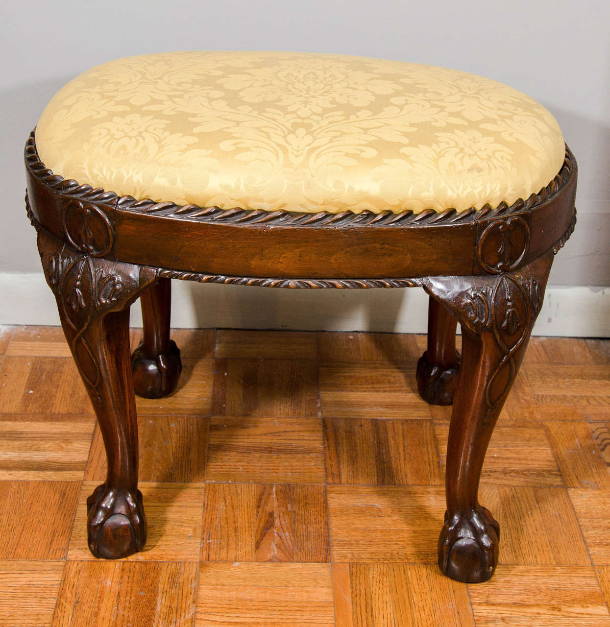 Pair of late 19th century mahogany stools with gadrooned edge and cabriole leg ending in ball and claw foot.