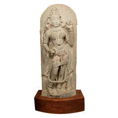 Carved stone Kwan Yin statue on wooden base.