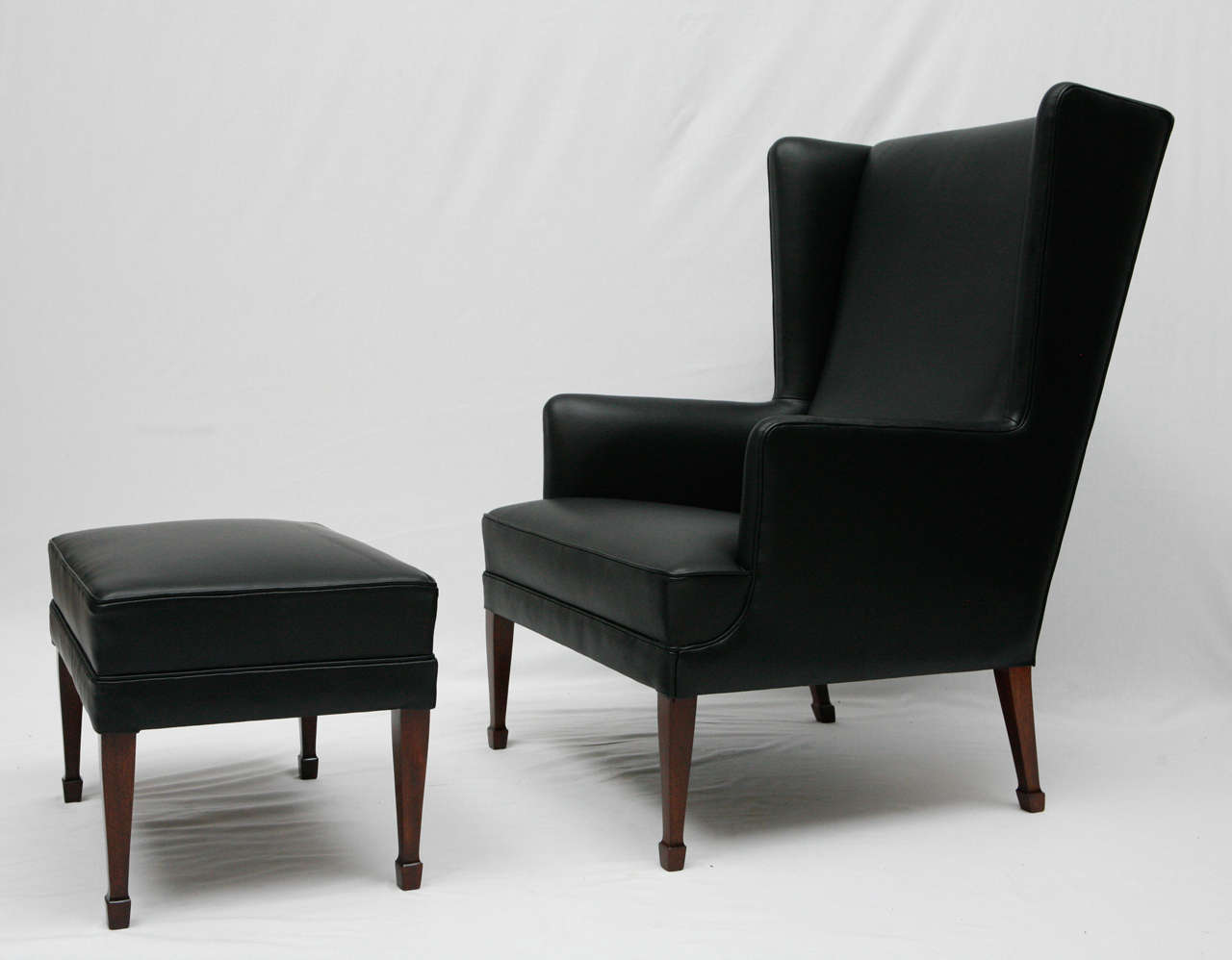 Frits Henningsen wingback chair reupholstered in new black leather.