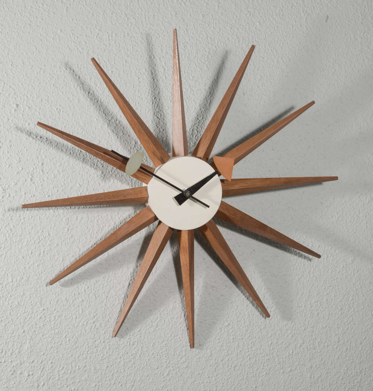 George Nelson spike clock by Howard Miller c. 1952 model 2202 in walnut and enameled metal.
