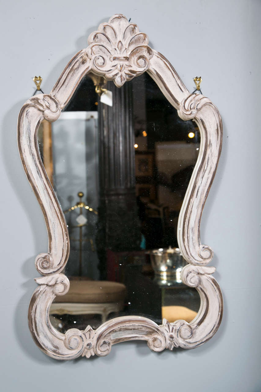 Pair of Rococo style mirrors, beautiful distressed white-painted frame decorated with shell motif and scrolls.