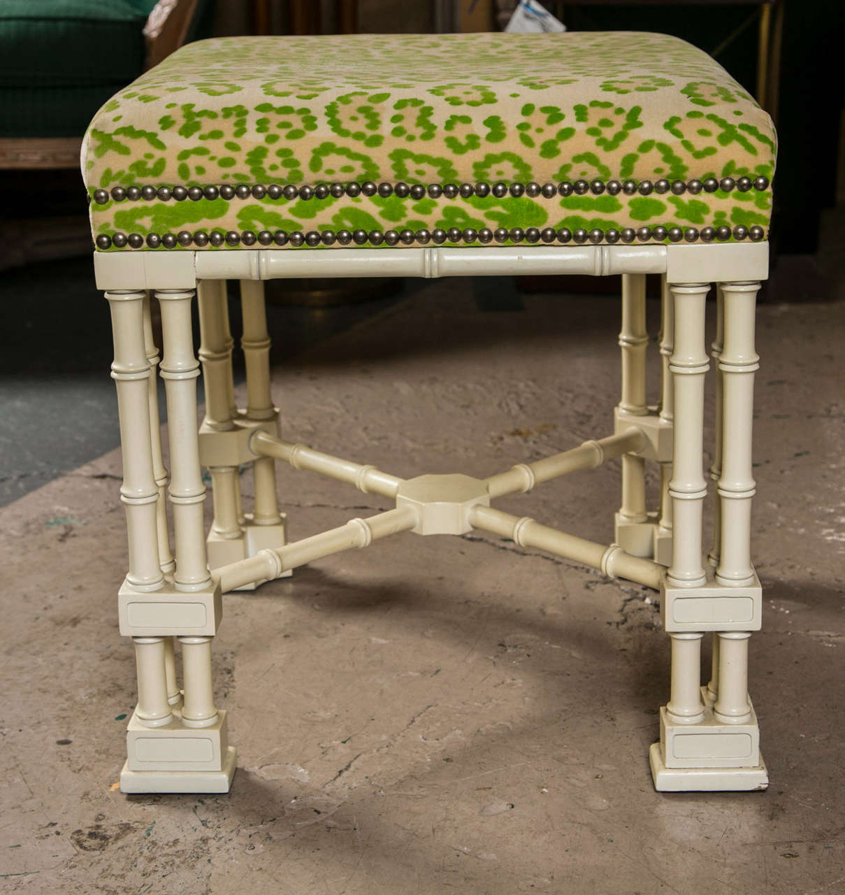Pair of stools on Hollywood Regency style, circa 1970s, the green/yellow patterned seat with nail heads supported on white painted faux bamboo base, joint by an X stretcher.