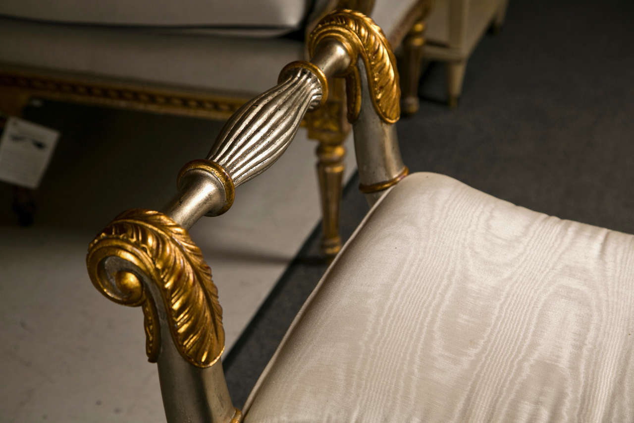 A charming vintage French Neoclassical style bench, in gorgeous silver and gold gilt, rolled arms, padded seat, concaved legs ending in claw feet. Comfort and style two in one. By Maitland Smith.