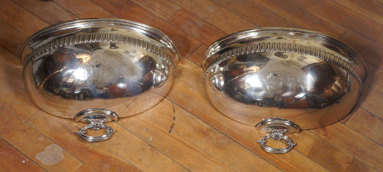 This pair of English planters made from a single silverplate Georgian style meat dome from the 19th century is in great shape and both are armorially engraved. Designed to have arrangements of flowers or ivy fitted down into the enclosed space of