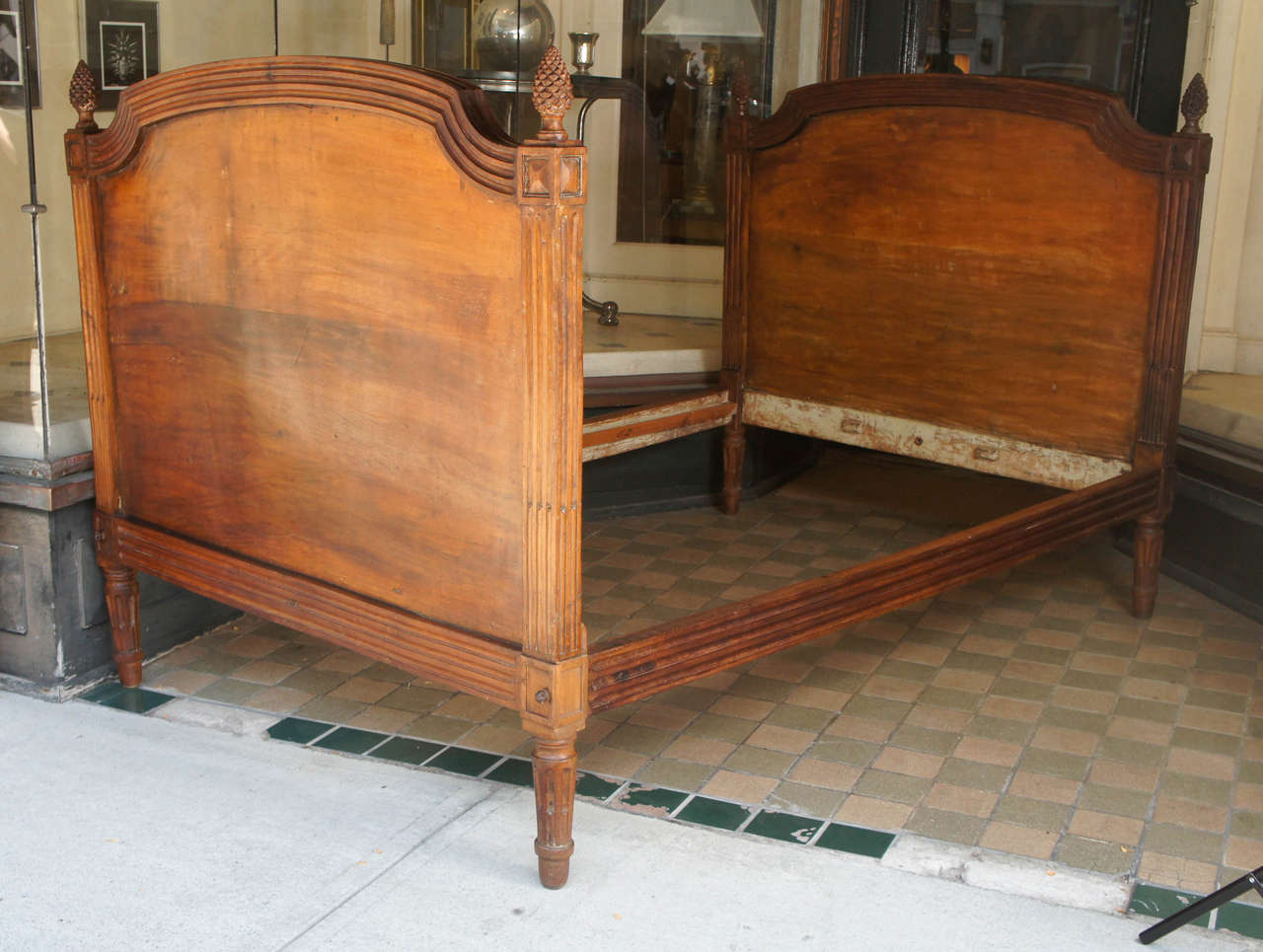 This fine bed made in circa 1780 in the Louis XVI style is constructed of walnut. The foot and headboard are carved with acorn finials centered on square carved panels connected with ogee carved sections. The entire bed is constructed with dowels