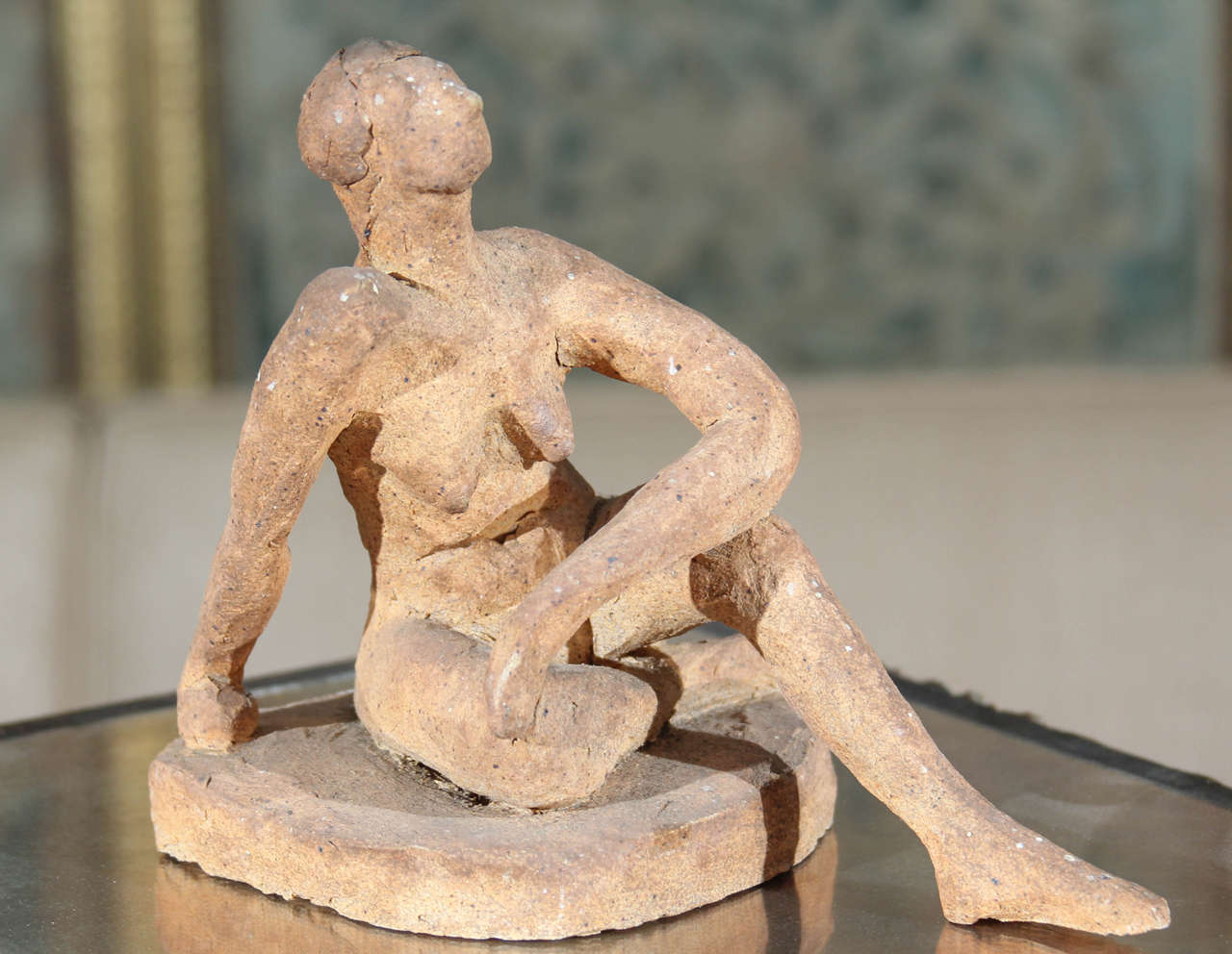 Small-scale clay nude sculpture.