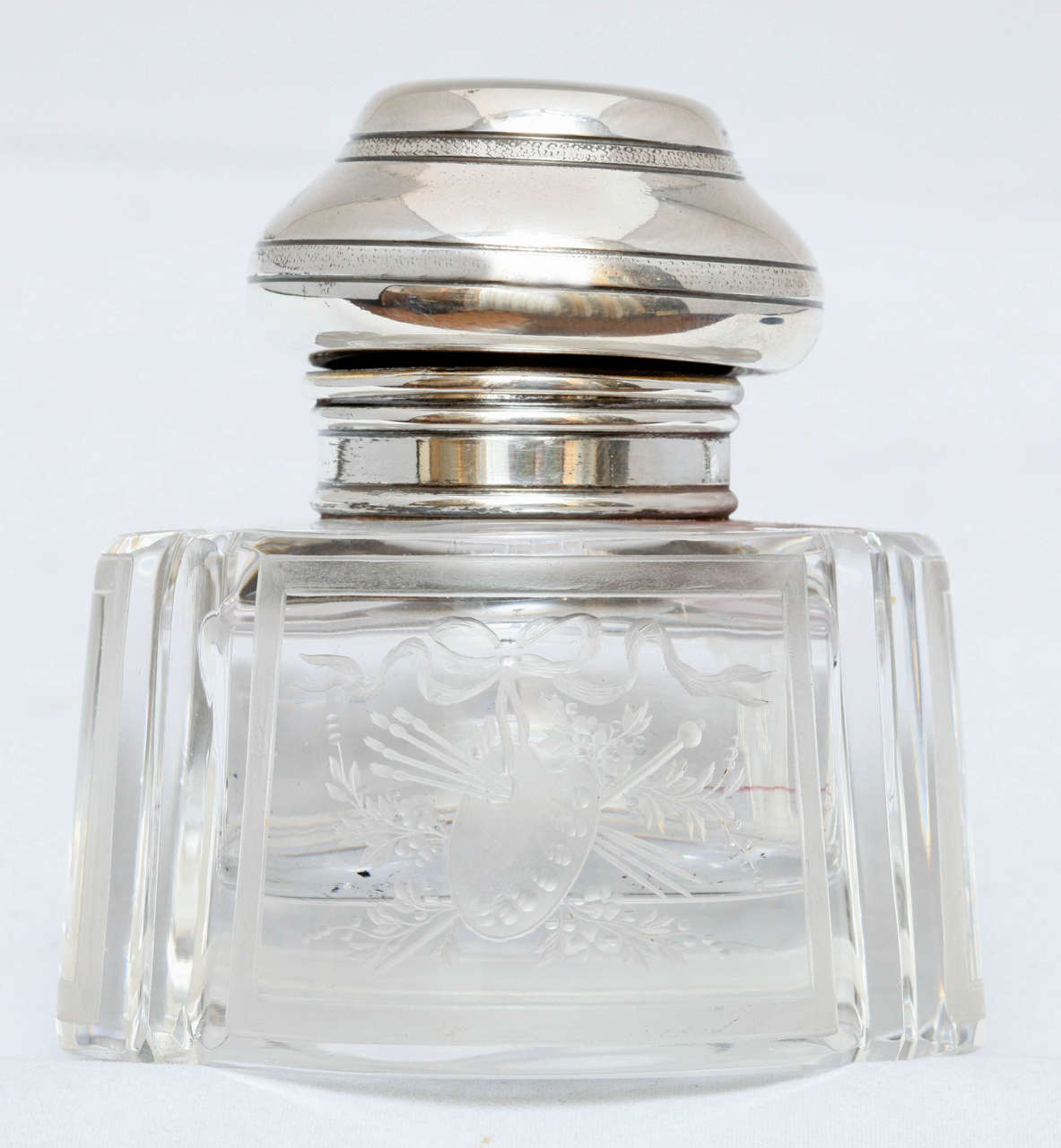 Sterling silver-mounted, etched crystal inkwell, The Gorham Corp., Providence, Rhode Island, year-marked for 1895. Crystal is centrally etched with an artist's palette and paint brushes which are surrounded by flowers and a bow. Measures: 3 3/4