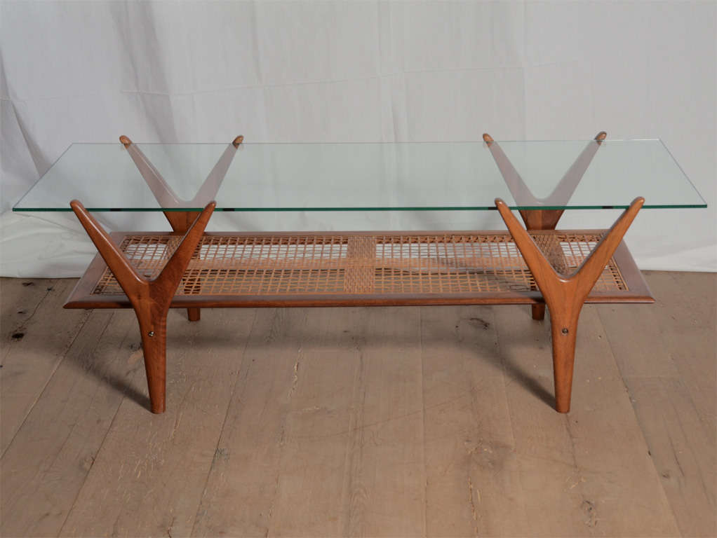 Beautiful Scandinavian Midcentury teak table with glass top and original caning on lower shelve