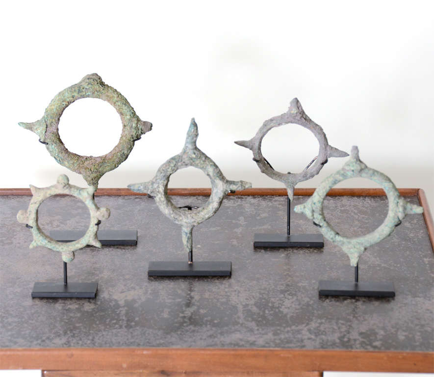 Set of antique bracelets with beautiful patina. Displayed on metal stands.