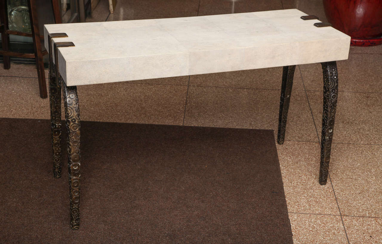 A rare French Art Deco style shagreen and patinated bronze three drawer desk, sofa table or console of the most unique shape embellished with four bronze legs and three drawers on the top, 20th century.