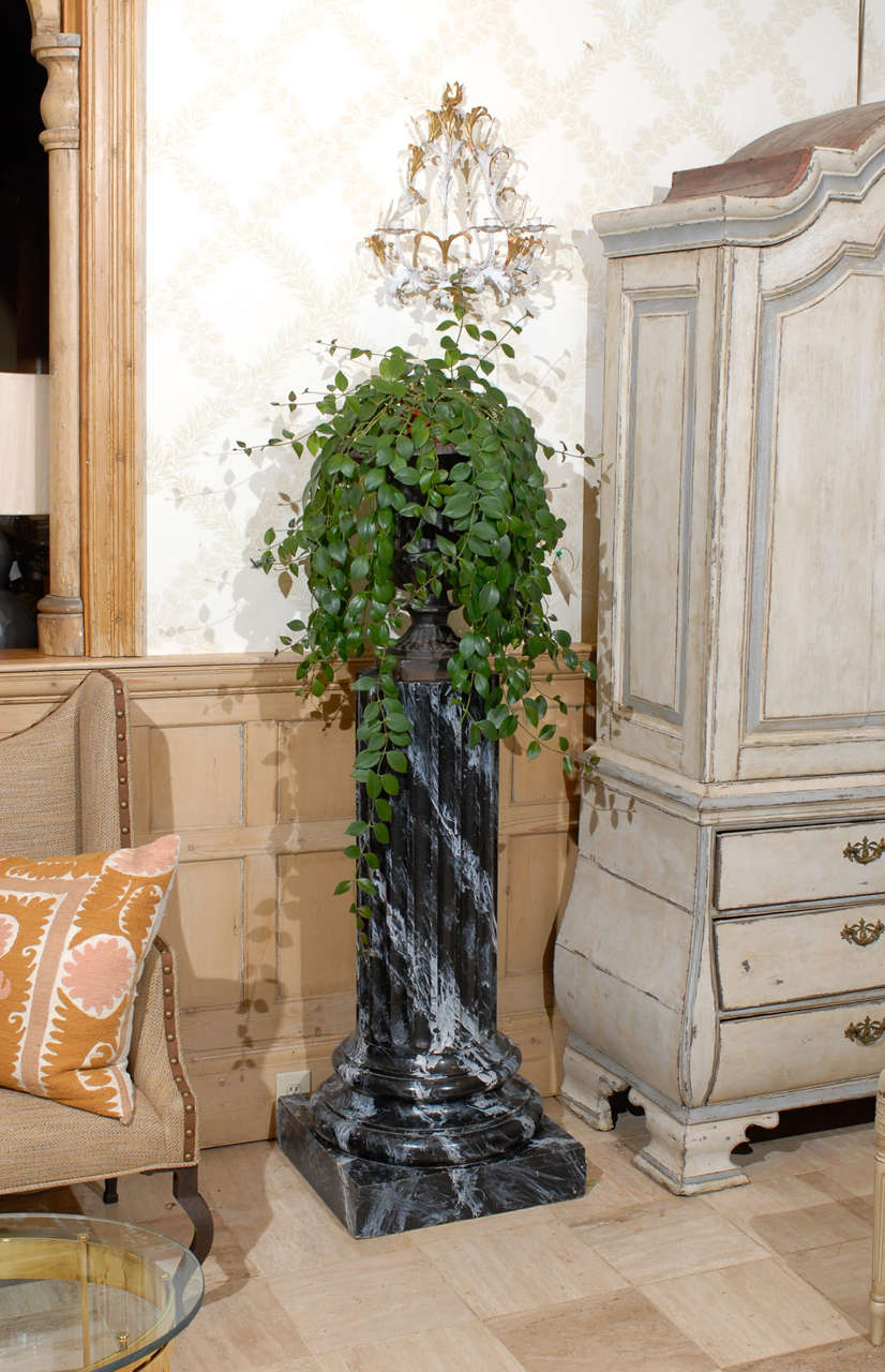 Early 20th Century Pair of Faux Marble Pedestals, Circa 1920
This pair of fluted columns are painted with a faux marble pattern that can enhance any room.  The tops are 12 inches in diameter. They are made of wood and are quite sturdy so they can