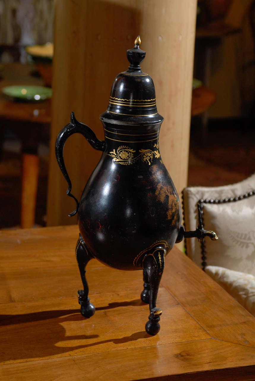 19th Century Black Tole Dutch Painted Samovar, Circa 1890
This lovely samovar is made of tole and has beautiful gold appointments on the legs and just below the lid.  The very talented artist has painted a quaint scene depicting an idyllic fishing