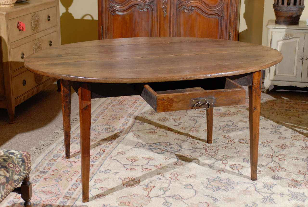 Here is a wonderful antique French oval farm table.  It is made in oak and has one drawer.  It would make a perfect breakfast room table and can seat six.