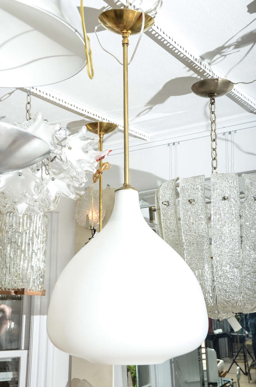 Frosted glass globe pendant with brass details. Takes a standard bulb.