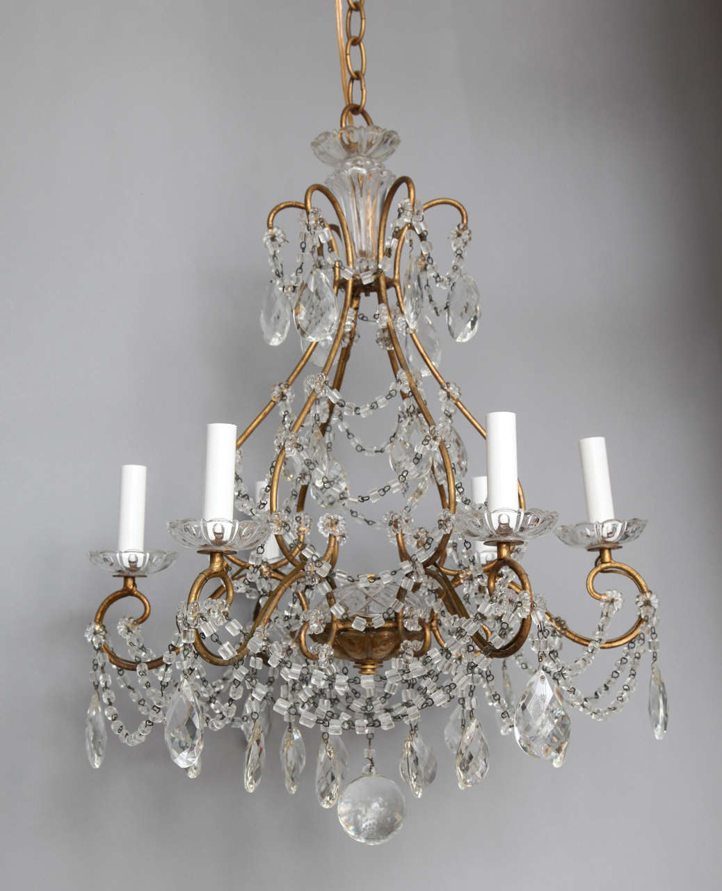 An Italian cage form gilt metal chandelier, the frame draped with strands of beads on chains.